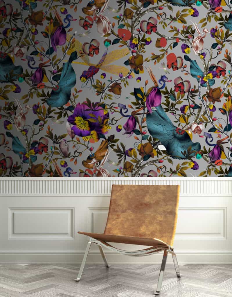 A colourful wallpaper above white panelling. A chair stood in front.