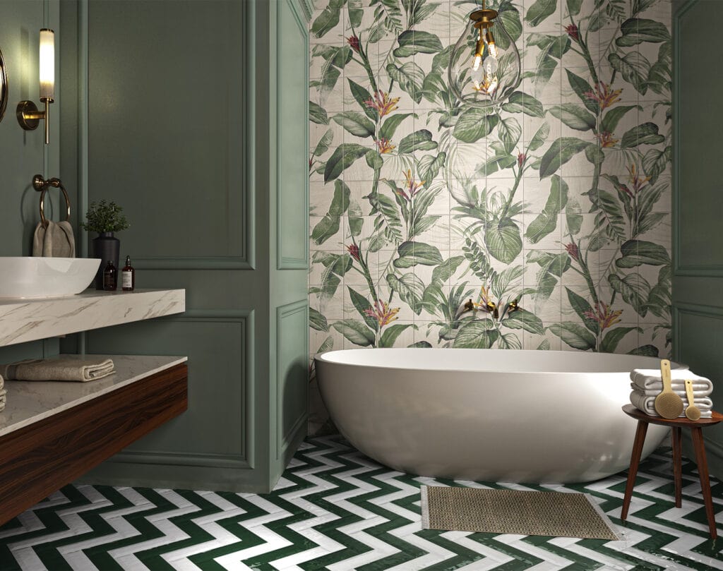 A bathroom with a tropical leaf foliage tiled feature wall, green panelling and a free standing bathub.