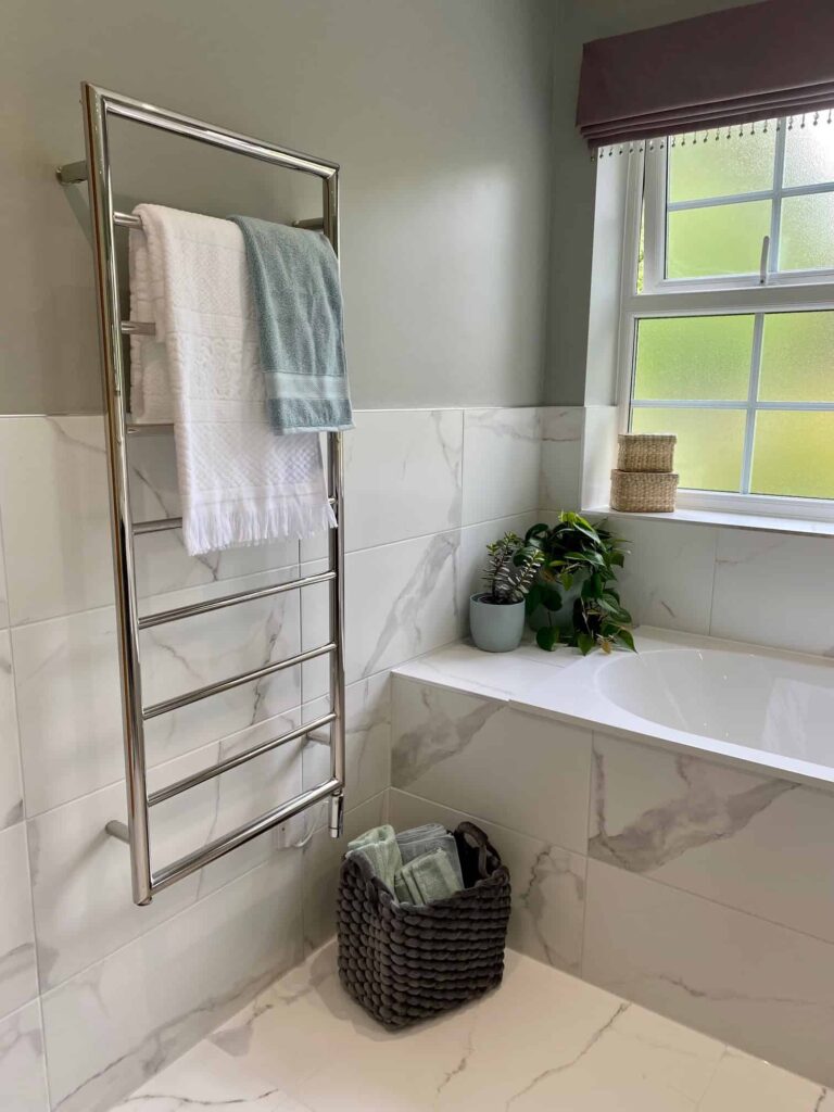 Fresh towels, baskets for storage and some plants freshen up a bathroom for spring.