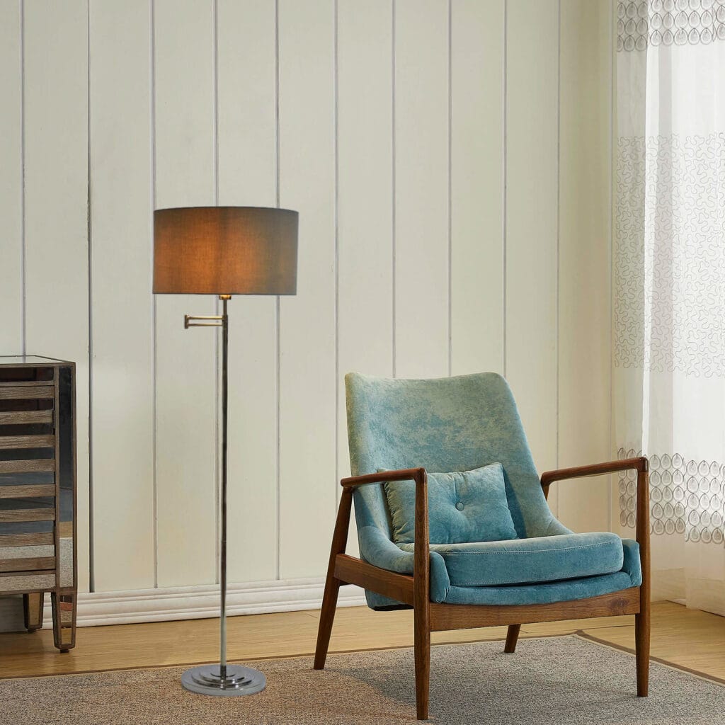 mid century style armchair with floor lamp stood behind standing on rug