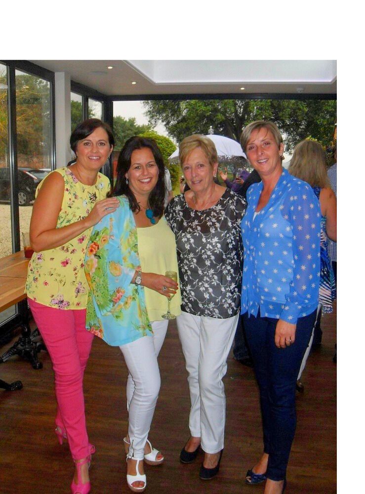 Jo with her mum and two sisters, all dressed in bright patterns