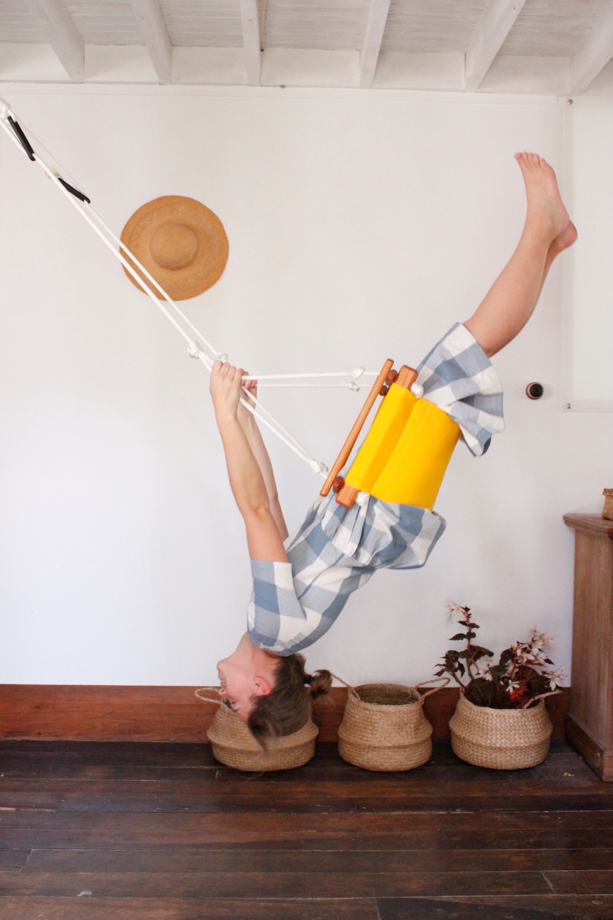 Alt text: An older child in a swing, almost upside down.