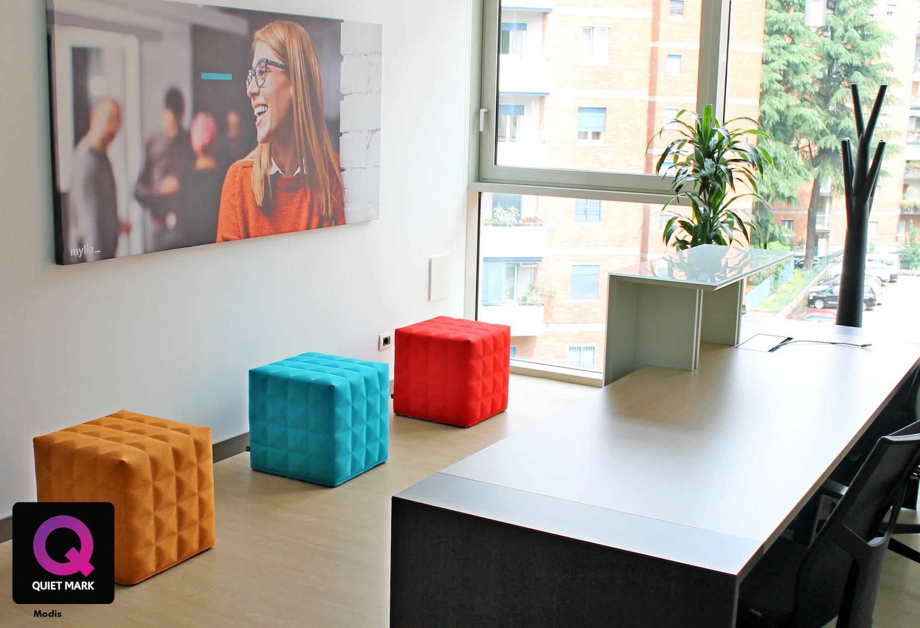 Colourful sensory cubes on a kitchen worktop beside a window, with a television mounted on the wall.